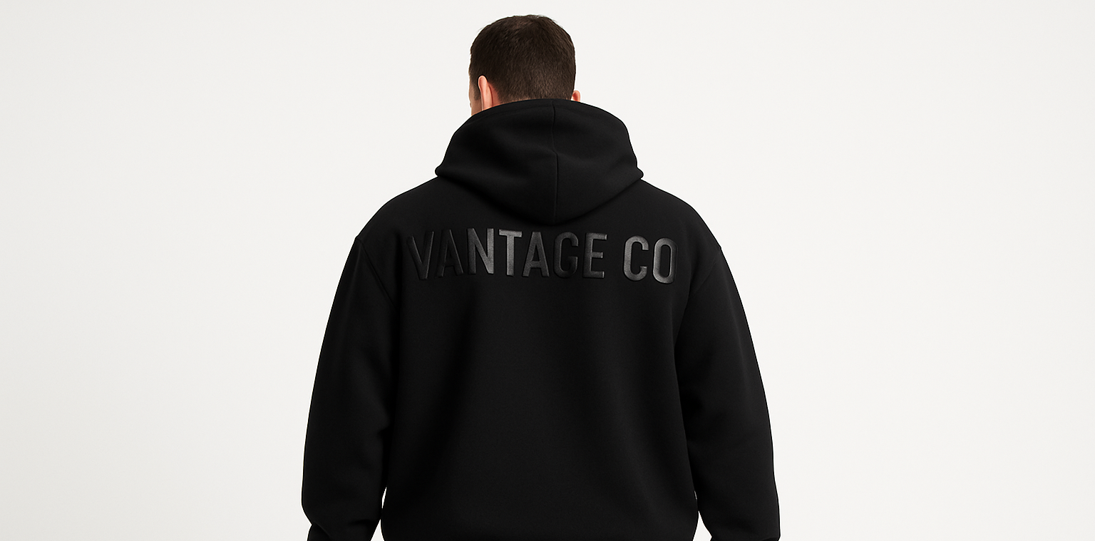 Hes facing away from the camera and the text is along the top back stretching from shoulder to shoulder 